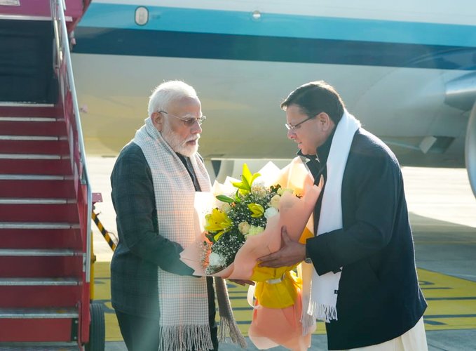 pm-modi-arrives-in-uttarakhand-cm-pushkar-dhami-welcomes-him-at-airport